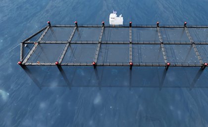 a render of a black rectangular shape floating in blue water with a small white boat adjacent to it